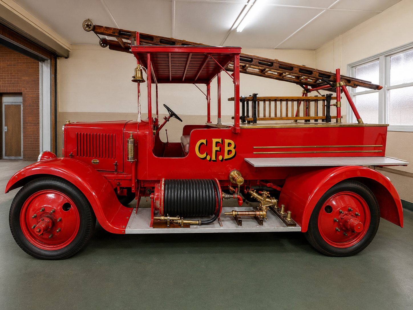 Restored 1923 Albion fire truck side view showing steel wheels, roof, ladder and side-mounted equipment